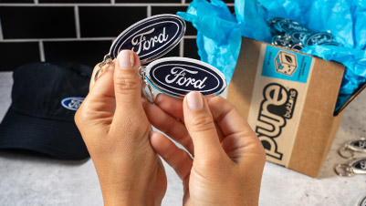 Unboxing custom oval keychains for Ford Motor Company