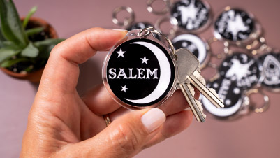Closeup of a round acrylic keychain for Salem Massachusetts