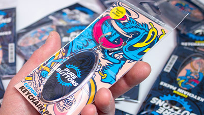 Oval Keychain Packs - Retail Packaging Closeup In Hand