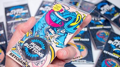 Round Keychain Packs - Retail Packaging Closeup In Hand