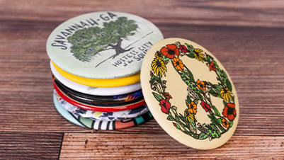 A Stack of 2.25 Inch Round Fridge Magnets with Custom Printed Artwork and Soft-Touch Matte Finish