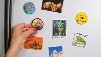 Hand Decorating a Refrigerator with a Variety of Custom Magnets