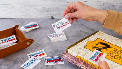 Hand Holding a Rectangle Sticker for Common Cause Which Reads "My Vote, My Future."