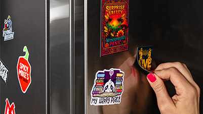 Hand Applying Flex Magnets to a Refrigerator