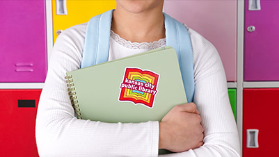 Student holding a notebook with a Custom Glitter Sticker applied